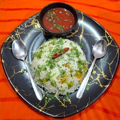 A picture of Rice Pulao with Tomato soup.