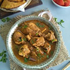 A picture of Kombdi Vade (Chicken Curry With Aromat Fried Flatbread).