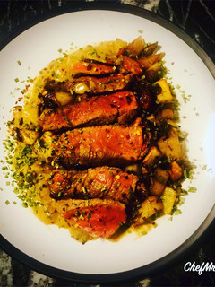 A picture of Ranch Steak with Roast Mix Potatoes, Red Onions and Peppercorn Sauce.