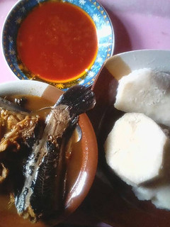 A picture of Boiled yam with palm oil and catfish pepper soup.
