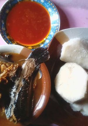 A picture of Boiled yam with palm oil and catfish pepper soup.