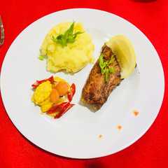 A picture of Grilled Salmon with Mashed Potato and Sauteed Baby Corn.