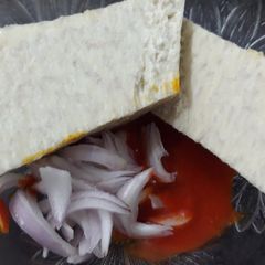 A picture of Boiled yam with red oil and onion.