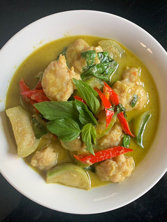 A picture of Green Curry with Pork Balls.