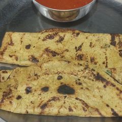 A picture of Besan chilla with tomato gravy.