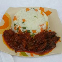 A picture of Veggie rice with dryfish stew.