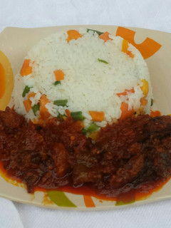 A picture of Veggie rice with dryfish stew.