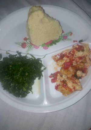 A picture of Fried eggs/kales and ugali.