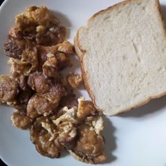 A picture of Fried eggs and bread for breakfast.