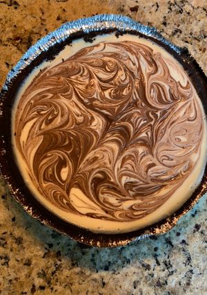 A picture of Cheesecake with Chocolate Fudge Swirl.