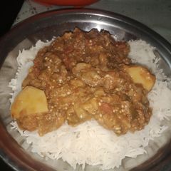 A picture of Bangan aloo With boiled rice.