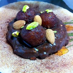 A picture of Chocolate instant browinee topped with gulab jamun.