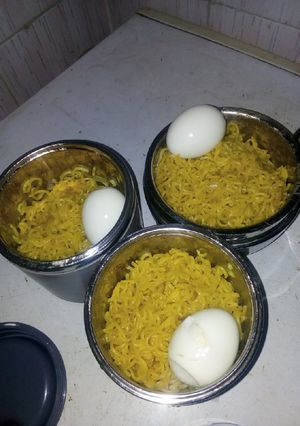 A picture of Turmeric Indomie with boiled egg.