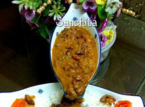 A picture of Rajma masala with rice and green salad.