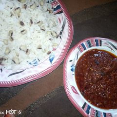 A picture of Rice n beans with stew.