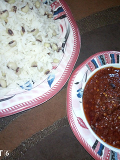 A picture of Rice n beans with stew.