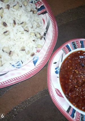 A picture of Rice n beans with stew.