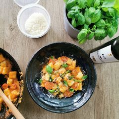 A picture of Potato Gnocchi, basil cherry tomato sauce.