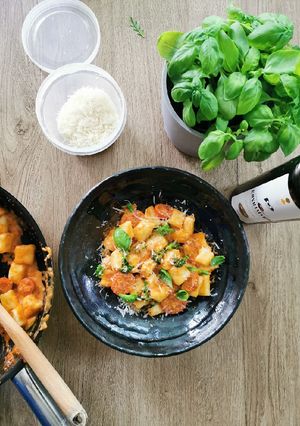 A picture of Potato Gnocchi, basil cherry tomato sauce.