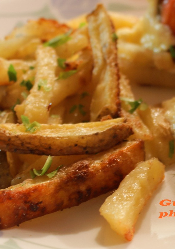 Una foto de Papas con queso parmesano y ajo al horno
