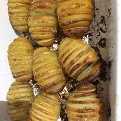 A picture of Hassleback rosemary and garlic new potatoes.