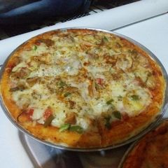 Chicken achari pizza A picture of Chicken achari pizza.