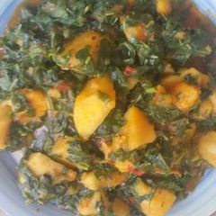 A picture of Porridge yam with spinach leave.