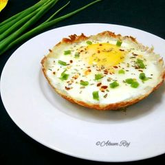 A picture of Egg And Cheese Topped Hash Brown Nest.
