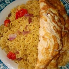 A picture of Noodles with fried egg.