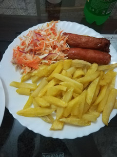 A picture of Chips, Sausage and Kachumbari.