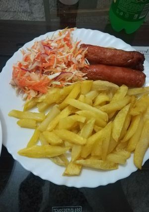 A picture of Chips, Sausage and Kachumbari.