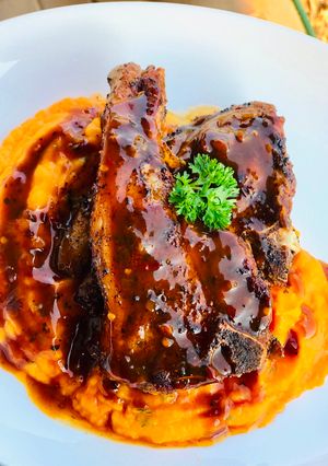 A picture of Pan fried lamb chops with herbed butternut mash.