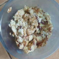 A picture of Scrambled eggs with onions.