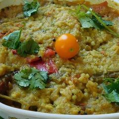 A picture of Drum stick tomato masala curry (sambar) mixed with rice.