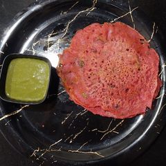 A picture of Beetroot Cheela with Coriander chutney.
