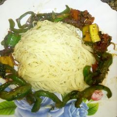 A picture of Spaghetti with stir fried veggies.
