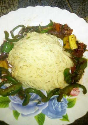 A picture of Spaghetti with stir fried veggies.