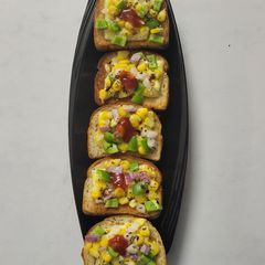 A picture of Corn 🌽 Capsicum 🫑 Cheesy Toast.