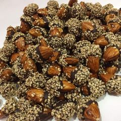 Chocolate badam coated with sesame seeds A picture of Chocolate badam coated with sesame seeds.