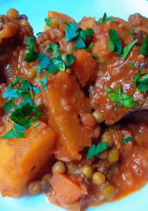 A picture of Beef Stew with Potatoes and Peas.