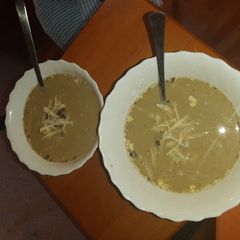 A picture of Sofie's Masala Dal Soup with cheese and sour cream.