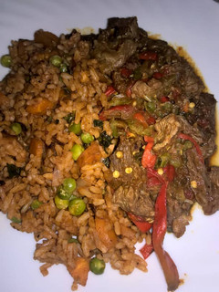 A picture of Tomato fried rice with shredded beef.