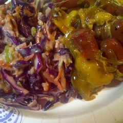 A picture of Hotdogs, onions, and red cabbage.