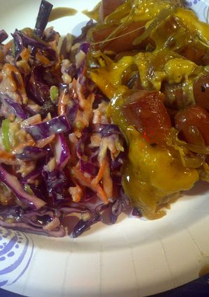 A picture of Hotdogs, onions, and red cabbage.