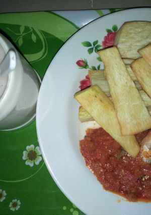A picture of Fried yam with fish stew.