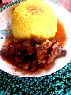 A picture of Turmeric rice with beef stew.