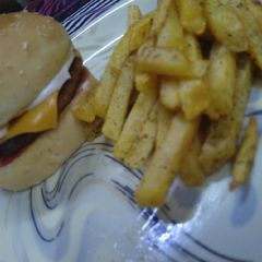 A picture of Chicken Cheese Burger with Fries.