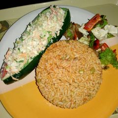 A picture of Cucumber Boat with chicken kebab.