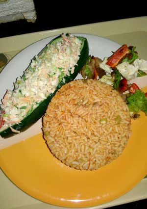 A picture of Cucumber Boat with chicken kebab.