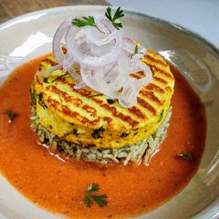 A picture of Paneer Steak on spinach rice with makhani gravy.